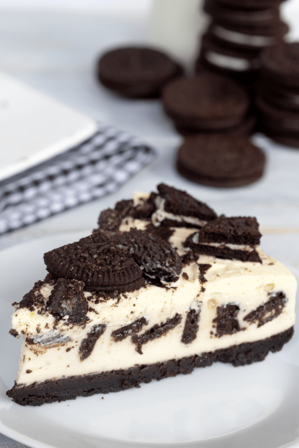 Slice of No-Bake Oreo Cheesecake served on a white plate. 
