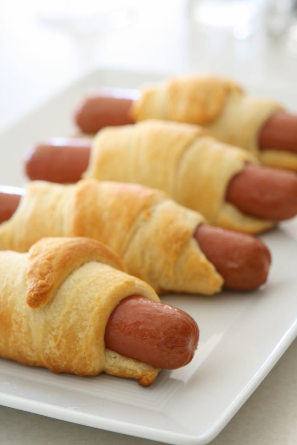 Pigs in a Blanket served on a plate. 