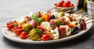 Antipasto Skewers with mozzarella, olives, ham, and herbs