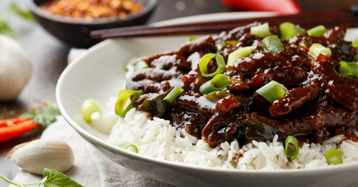 A Plate of Mongolian Beef with Rice and Green Onions