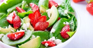 Bowl of Summer Salad with Spinach, Avocado and Strawberries