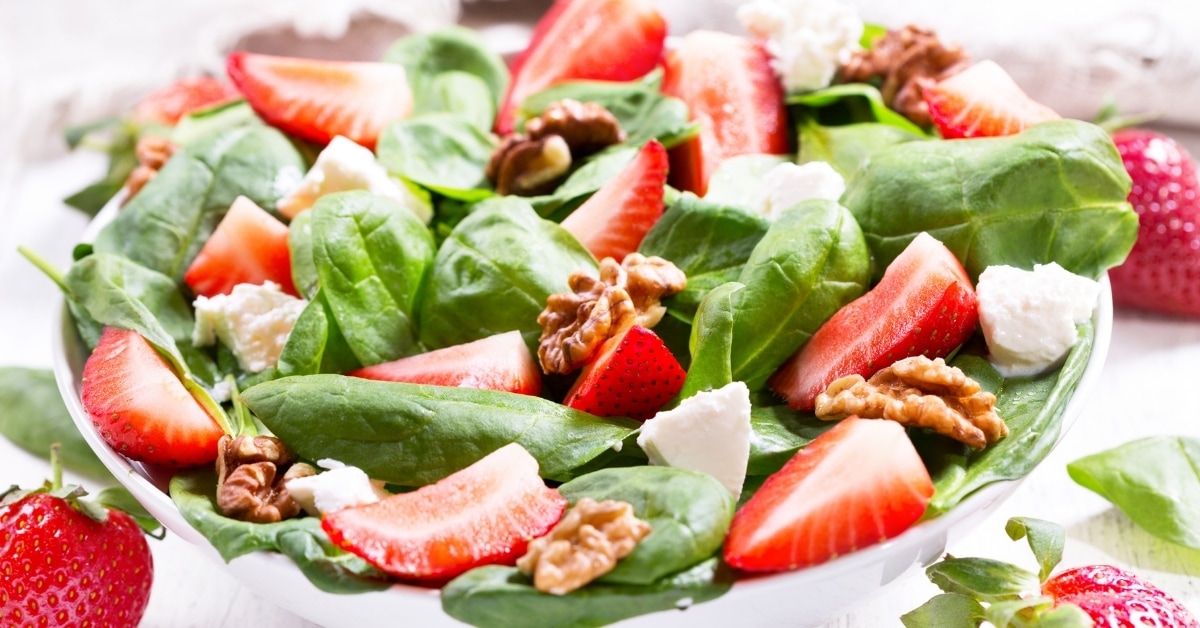 Bowl of Strawberry Spinach Salad with Feta Cheese and Pecan Nuts