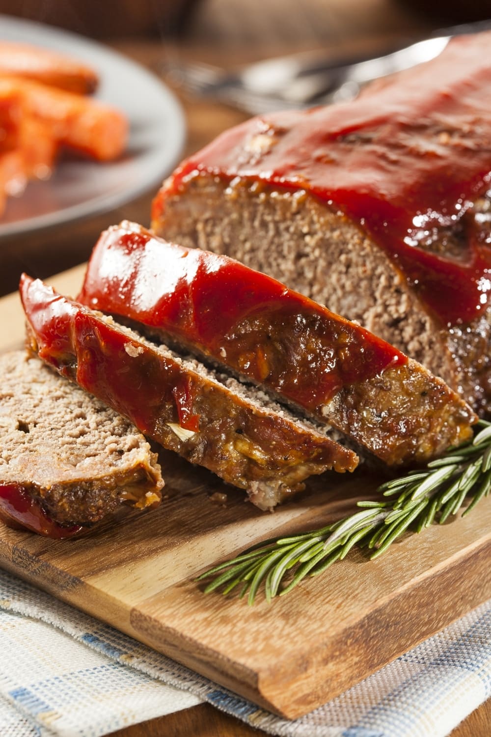 Ground Beef Meatloaf with Ketchup in a Wooden Board