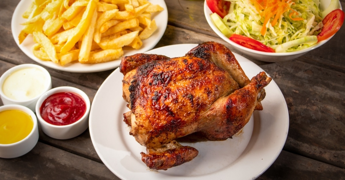Peruvian Roasted Chicken with Dipping Sauce French Fries and Vegetable Salad