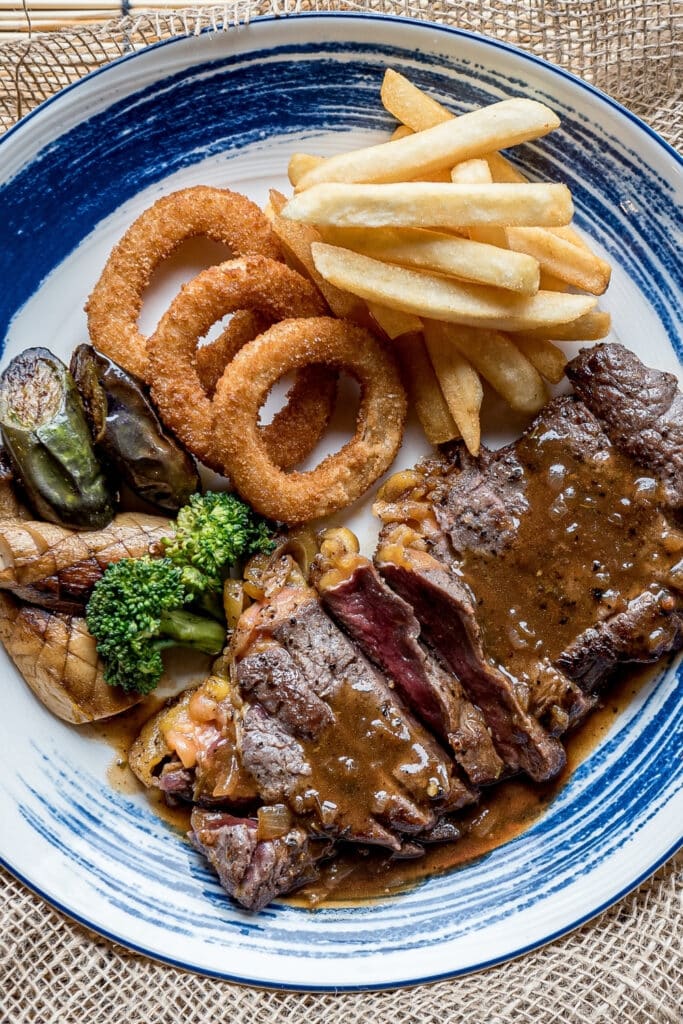 Sirloin Tip Steak with Fried Onions and Vegetables and French Fries