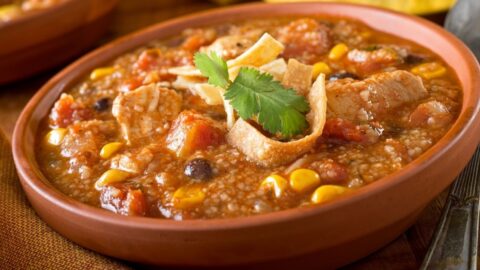 A Bowl of Chicken Tortilla Soup with Corn, Black Beans and Tomatoes