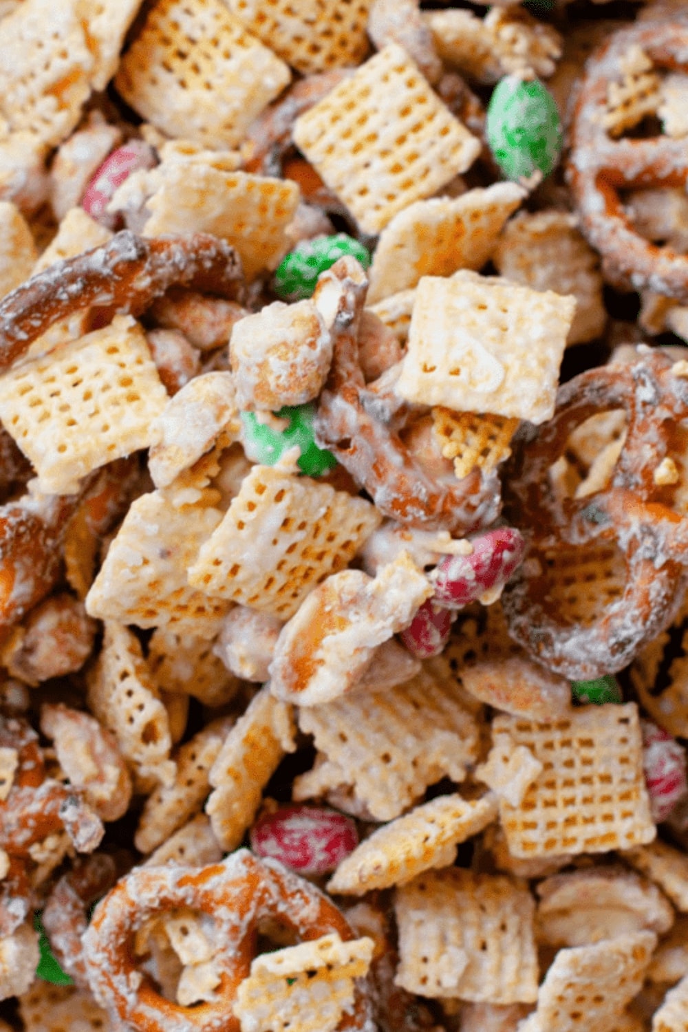 Mixture of Chex, pretzels, peanuts, and M&Ms, covered in melted white chocolate.