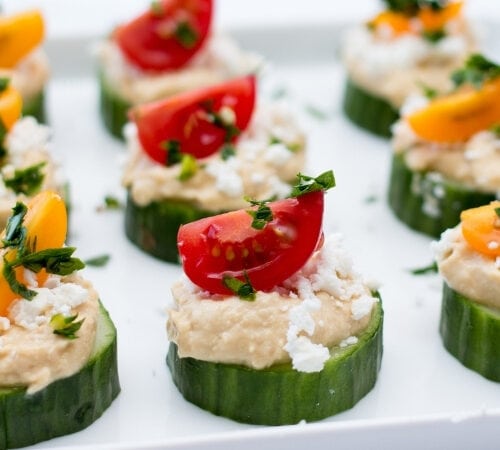 https://insanelygoodrecipes.com/wp-content/uploads/2021/07/Cucumber-Bites-with-Hummus-and-Tomatoes-500x450.jpg