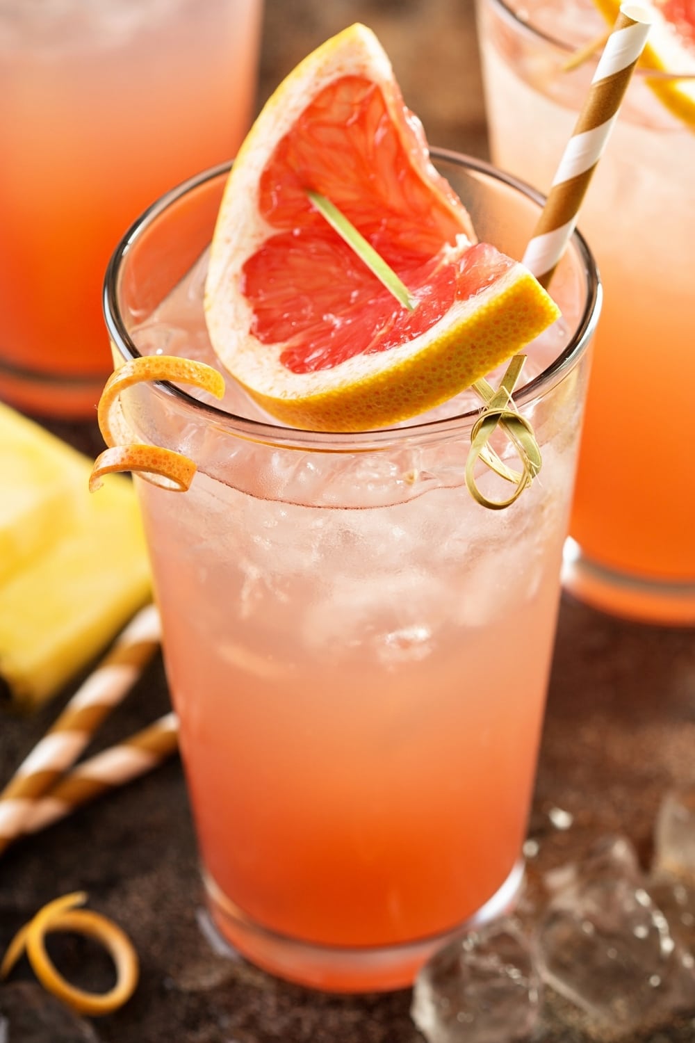 Grapefruit and Pineapple Mocktail served on a glass garnished with a slice of grapefurit. 