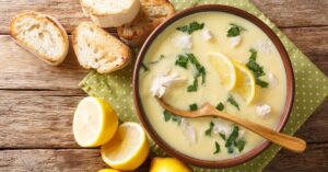 Greek Lemon Chicken Soup or Avgolemono with Bread and Fresh Lemons