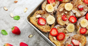 Homemade Baked Overnight French Toast Topped With Berries and Banana Slices