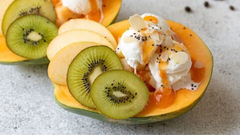 Homemade Papaya Boat Dessert with Ice Cream and Fruits
