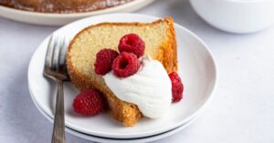 Slice of Homemade Pound Cake with Fresh Strawberries and Whipped Cream