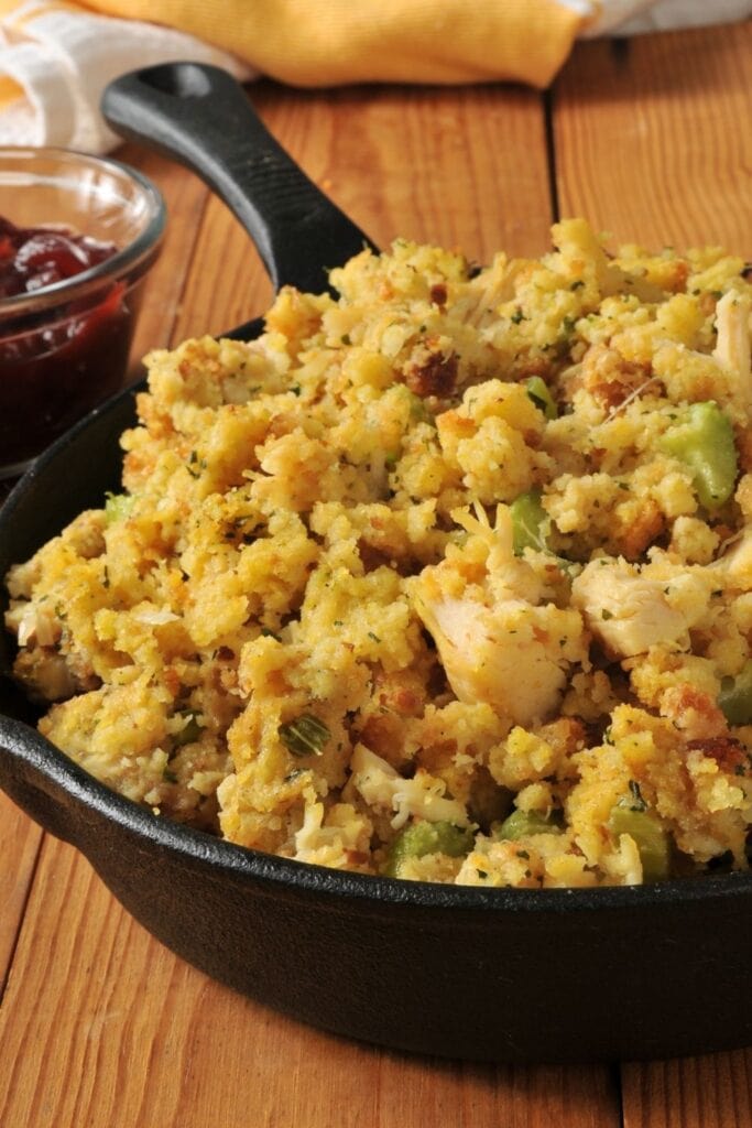 Cornbread Stuffing in a Cast Iron Skillet with Cranberry Sauce