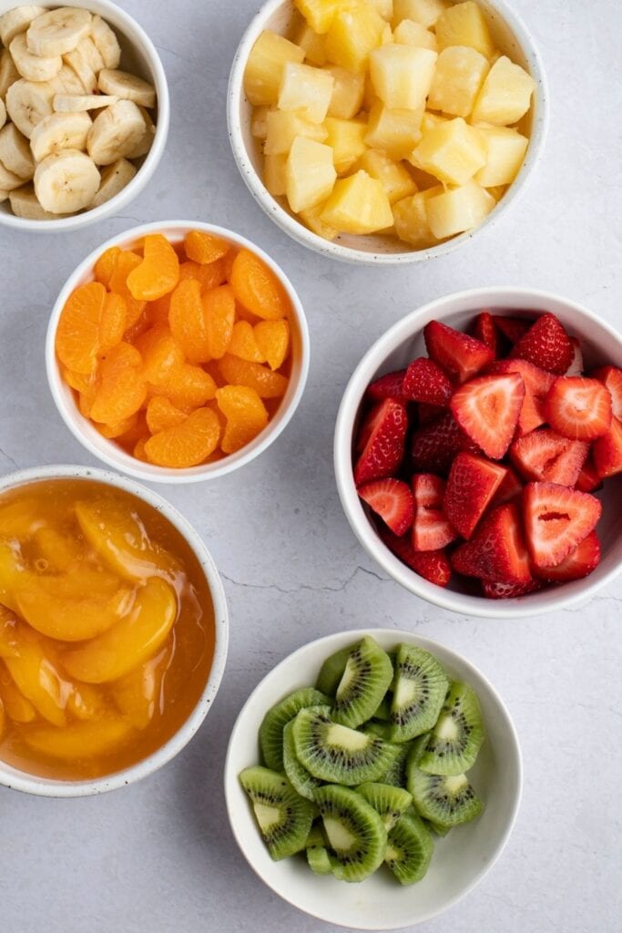 Fruit Salad Ingredients: Oranges, Strawberries, Pineapples, Kiwis, Bananas and Peach Pie Filling