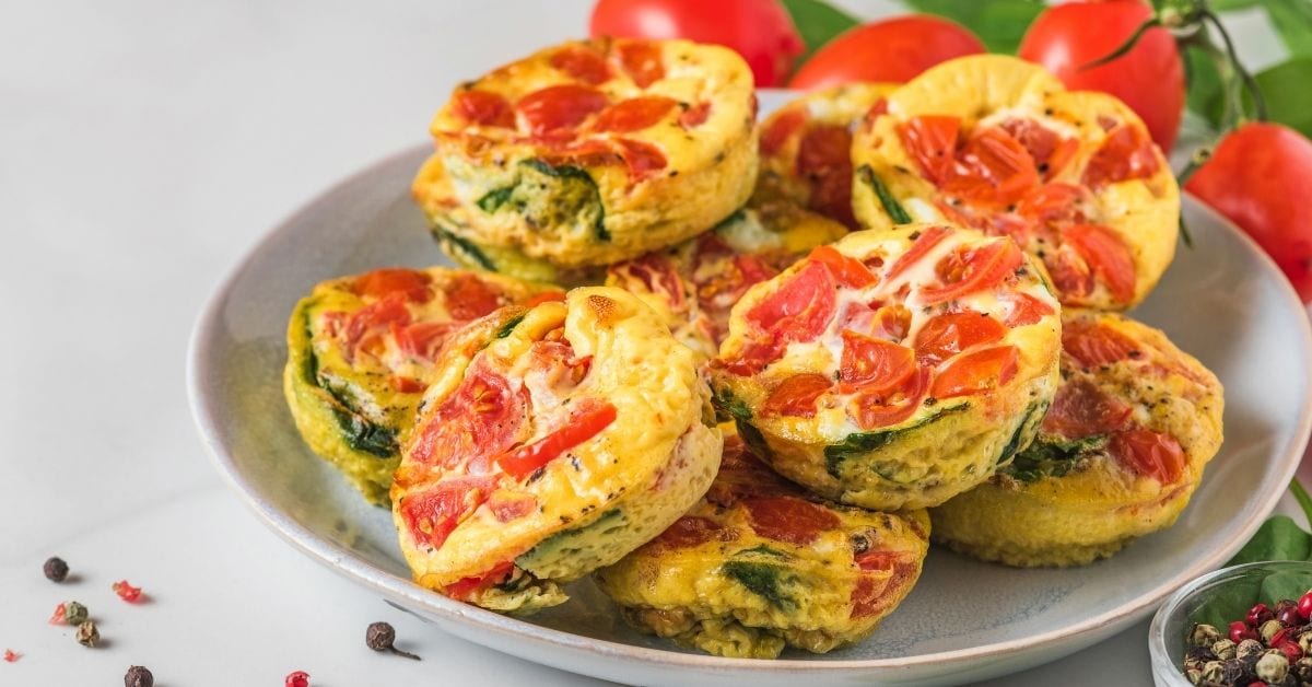 Homemade Egg Muffins with Tomatoes and Spinach on a Plate
