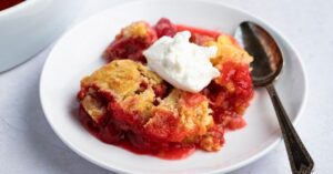 Homemade Soft and Crumbly Rhubarb Dump Cake with Ice Cream in a Plate