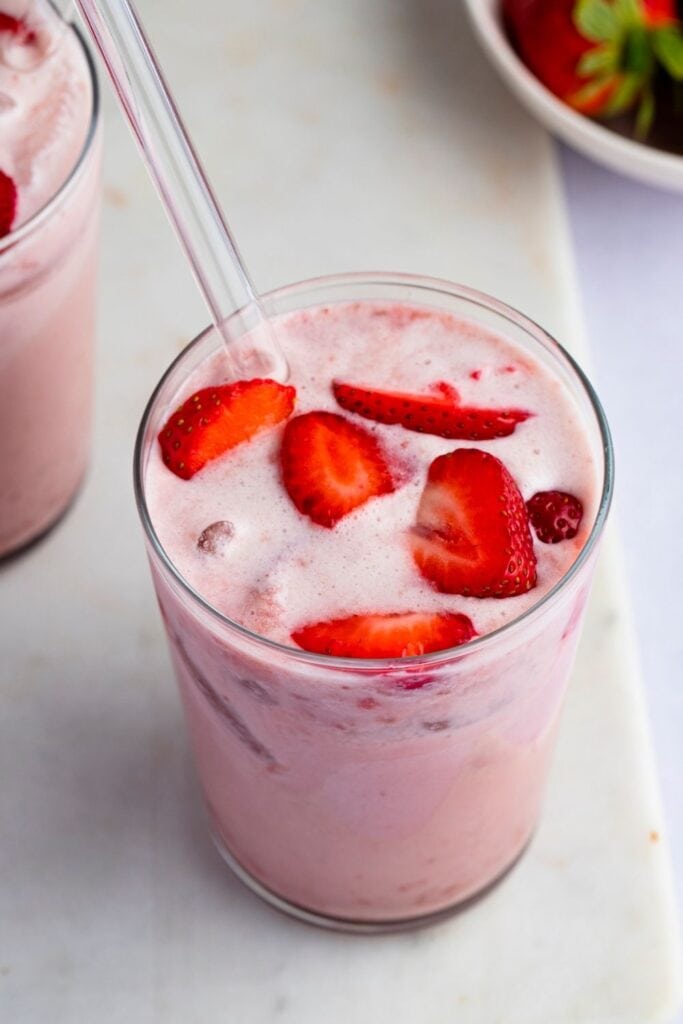 Homemade Strawberry Pink Drink in a Glass with Fresh Strawberries