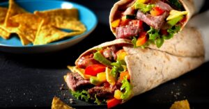 Homemade Tortilla Wraps with Beef Steak, Vegetables and Nachos