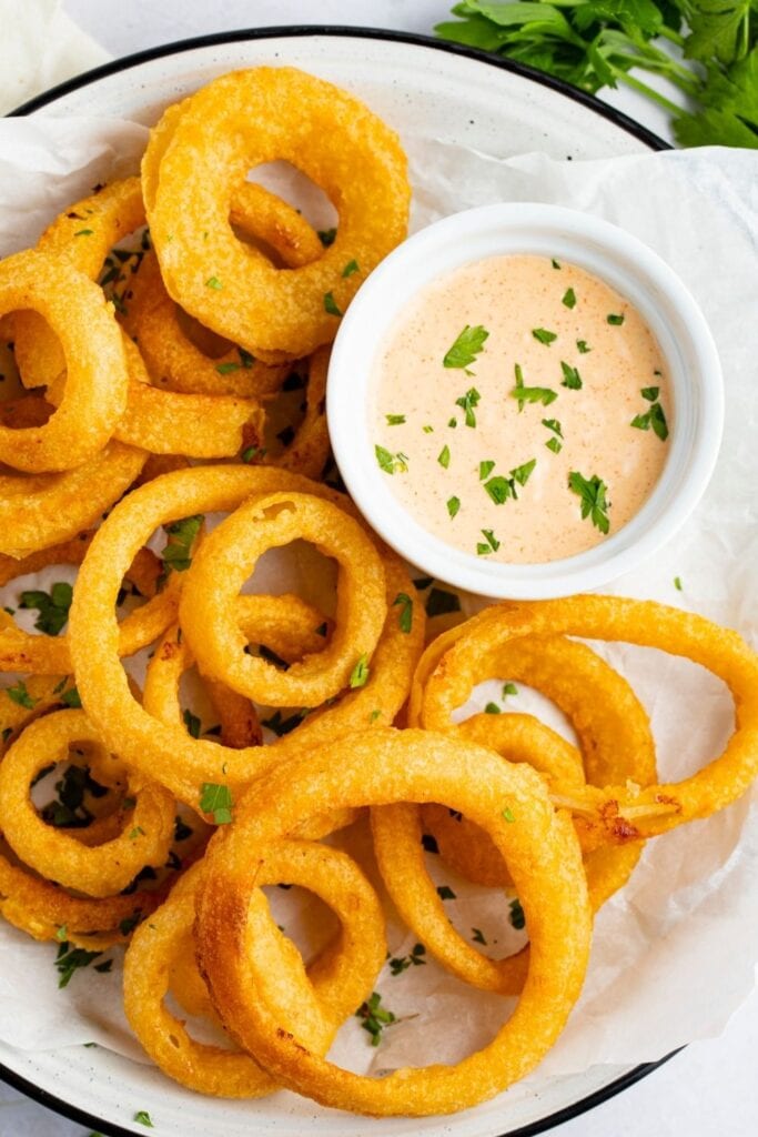Savory Zesty Sauce with Onion Rings on a Plate