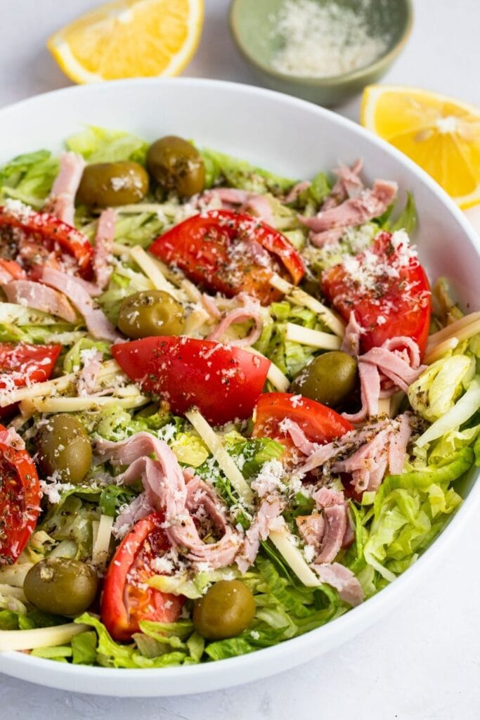 1905 Salad with Lettuce, Ham, Olives and Tomatoes in a Bowl