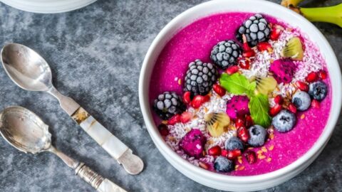 A Bowl of Dragon Fruit Smoothie with Banana and Berries