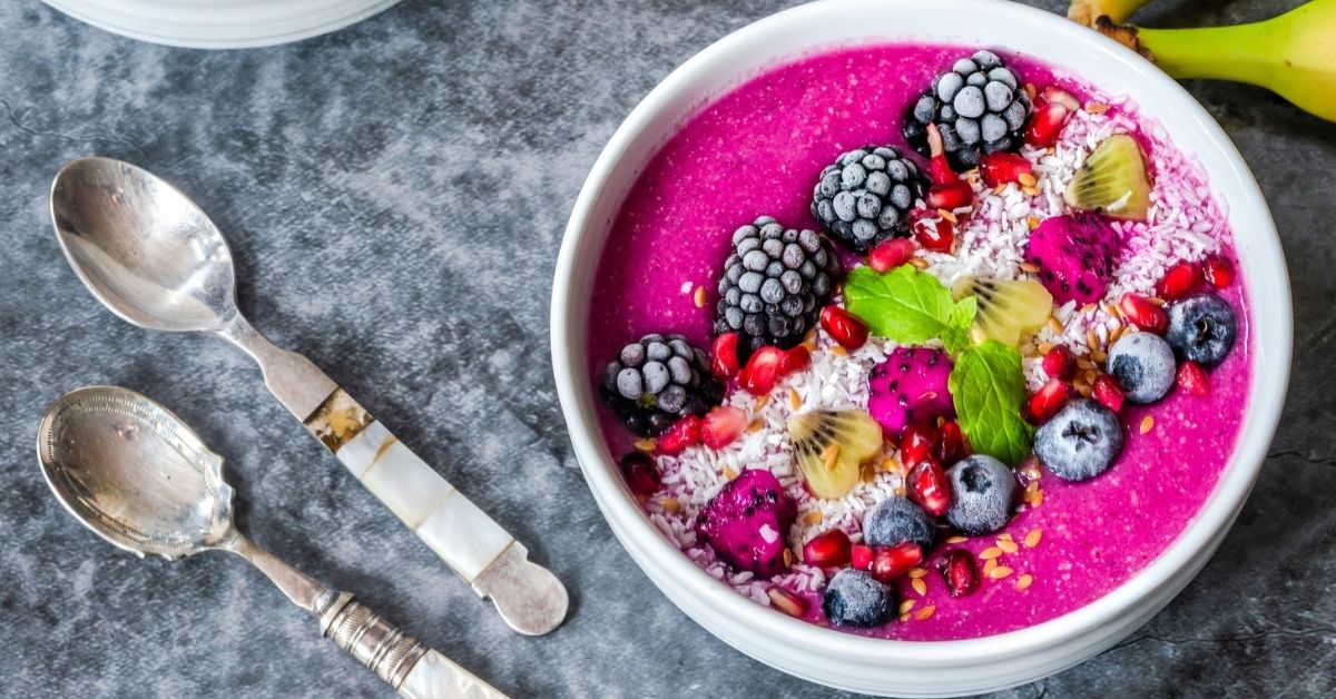 A Bowl of Dragon Fruit Smoothie with Banana and Berries