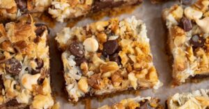 Hello Dolly Bars Topped with Nuts, Chocolate Chips and Shredded Coconut