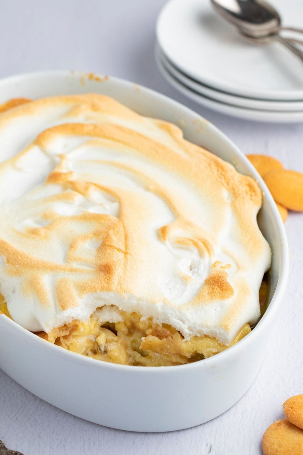 Banana Pudding Casserole With Meringue On Top In A White Dish.