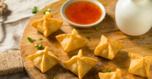 Homemade Deep Fried Rangoon with Chopped Onions and Dipping Sauce
