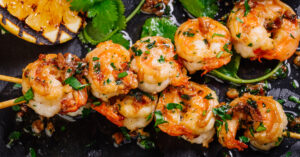 Roasted Shrimp on Skewers with Sauce and Lemons