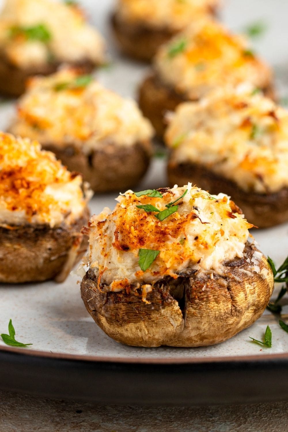 Crab Stuffed Mushrooms served on a gray plate. 