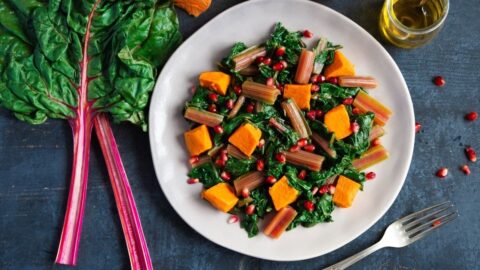 Boiled Swiss Chard with Sweet Potatoes and Pomegranate in a Plate
