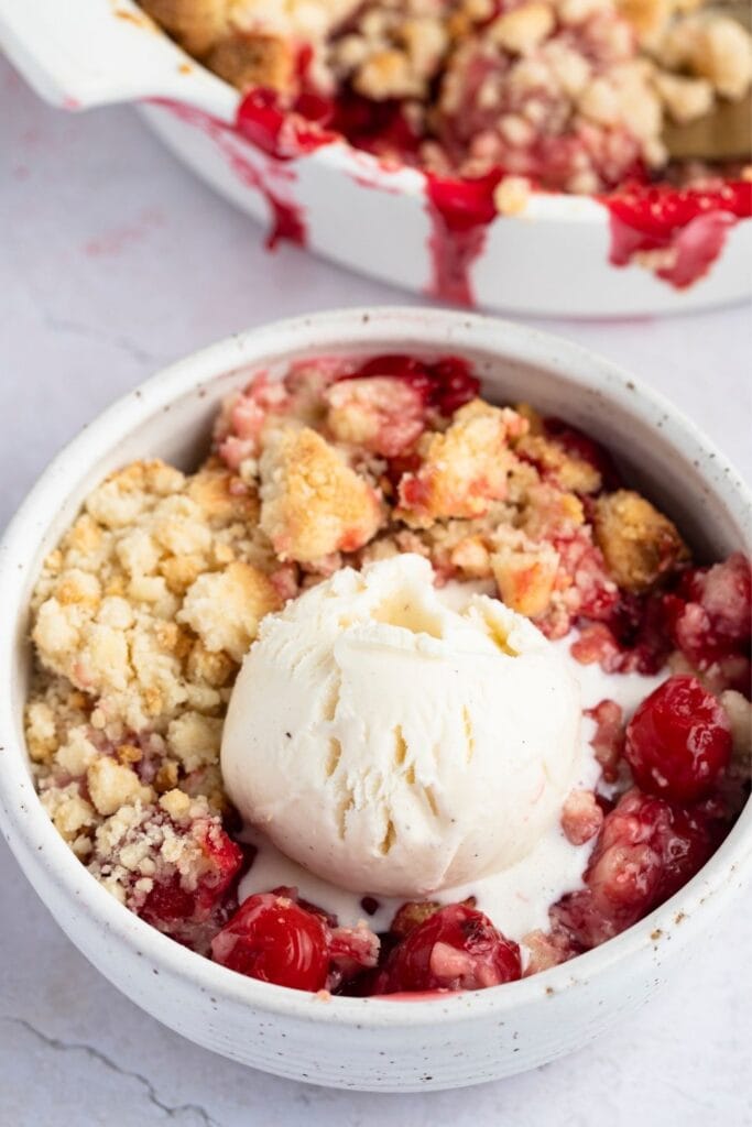 Bowl of Cherry Cobbler with Ice Cream and Cherries