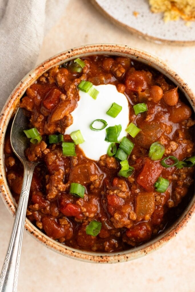 Bowl of Chili with Whipped Cream and Onions