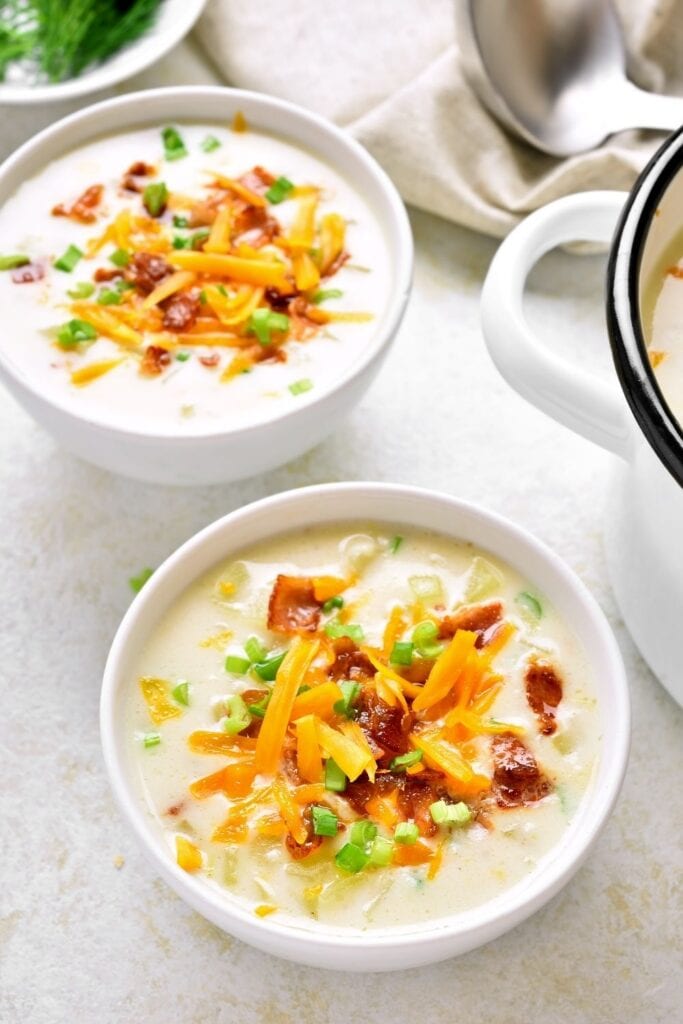Bowl of Potato Soup with Shredded Cheese, Bacon and Green Onions
