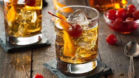 Cold Old Fashioned Cocktail with Cherries and Orange