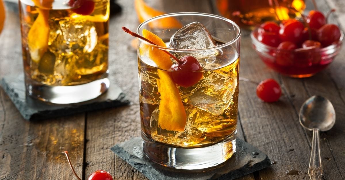 Cold Old Fashioned Cocktail with Cherries and Orange