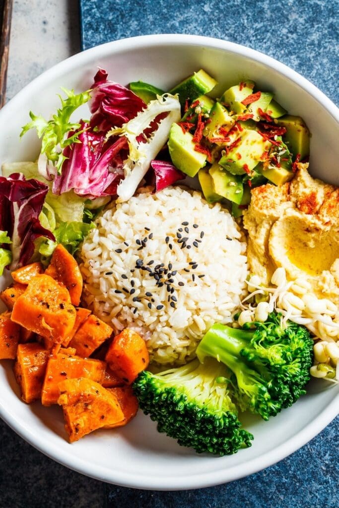Healthy Buddha Bowl with Rice, Vegetables, Hummus and Avocados