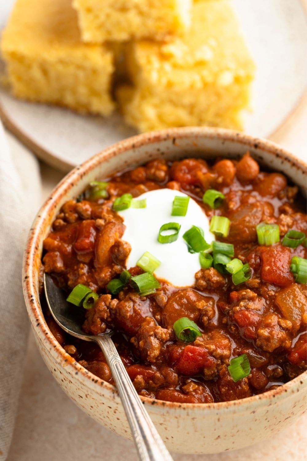 Homemade Hearty and Creamy Rotel Chili with Whipped Cream and Green Onions