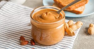 Peanut Butter in a Glass Jar with Bread