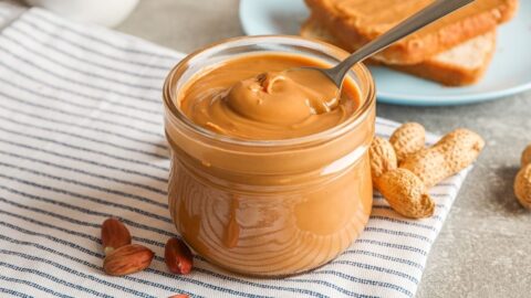 Peanut Butter in a Glass Jar with Bread