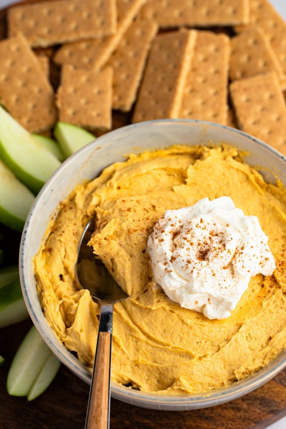 Pumpkin Fluff Dip with Whipped Cream and Sprinkled Cinnamon on Top