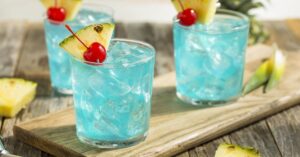 Refreshing Blue Hawaiian Cocktail Punch with Pineapple and Cherry