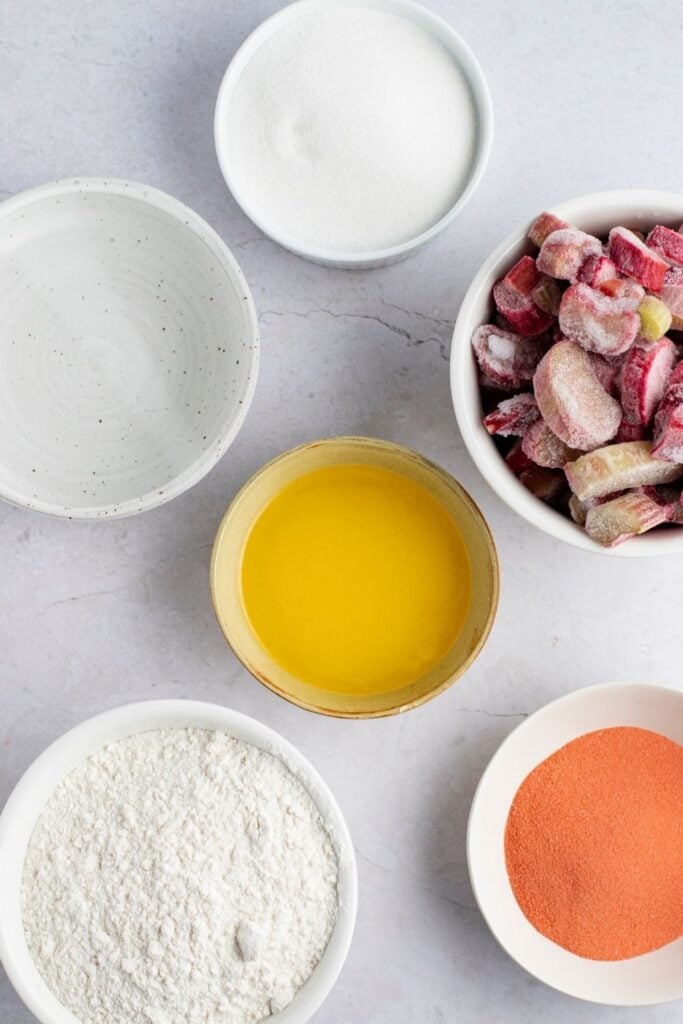 Rhubarb Dump Cake Ingredients: Rhubarb, Granulated Sugar, Strawberry Gelatin Mix, Yellow Cake Mix, Water and Margarine