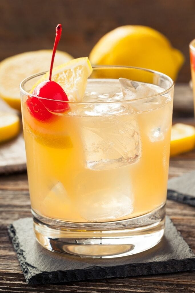 Scotch Sour Cocktail with a Maraschino Cherry and Lemon Wedge