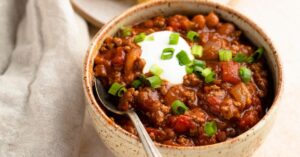 Spicy Homemade Rotel Chili with Whipped Cream and Green Onions
