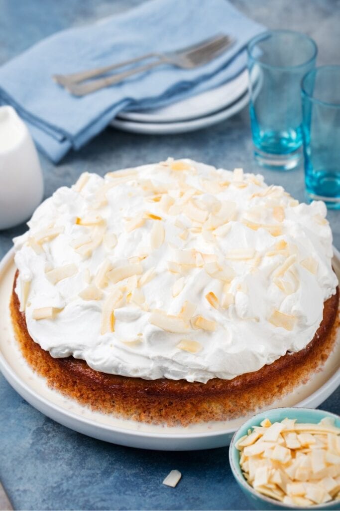 Tres Leches Cake Topped with Toasted Coconut and Whipped Cream