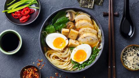 A Bowl of Ramen Noodle Soup with Boiled Eggs, Tofu and Chicken