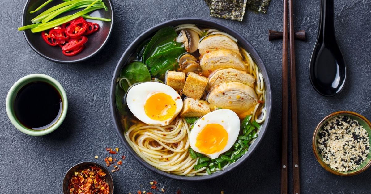 A Bowl of Ramen Noodle Soup with Boiled Eggs, Tofu and Chicken